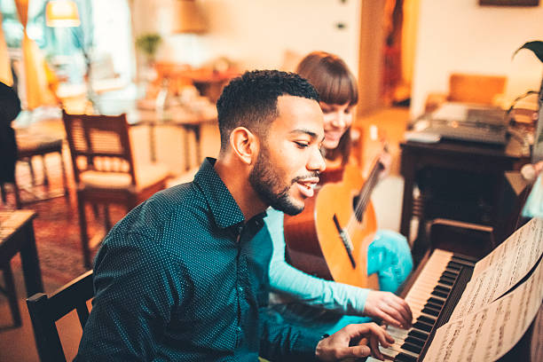 istock Young adults playing piano together 519397066