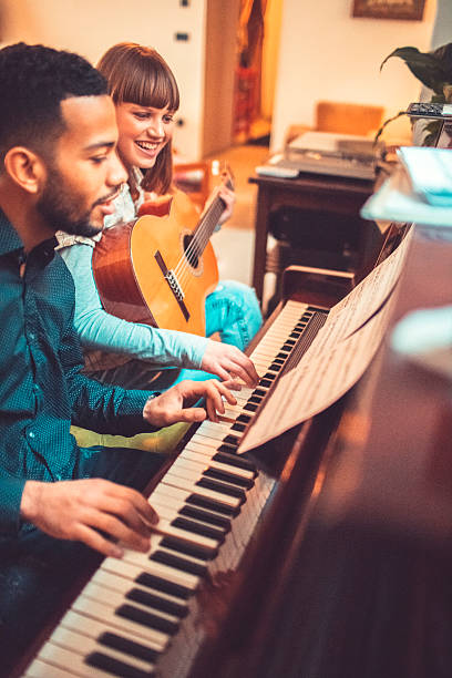 istock Young adults playing piano together 519397094