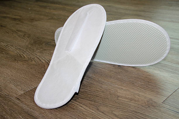 istock white sandals on wooden floor 519399304