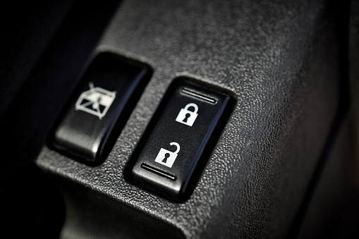 Car lock and unlock button with window lock and shallow depth of field