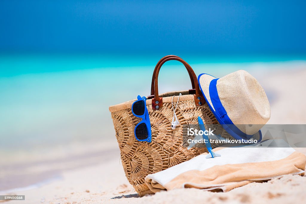 Beach accessories - bag, straw hat, sunglasses on white beach Africa Stock Photo