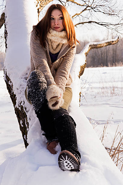 istock Cute blond sitting in a winter park, sunny day. 519404493