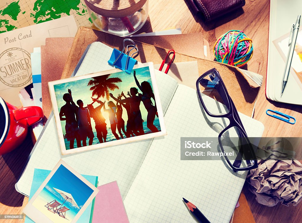 Desk with Summer Photographs and Notebook Adhesive Note Stock Photo