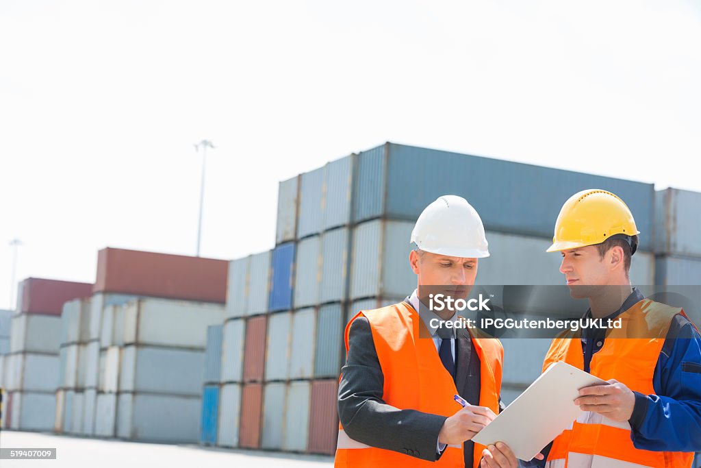 Worker taking sign of supervisor on clipboard in shipping yard 30-34 Years Stock Photo