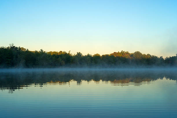 istock Sunrise with mist over water at Toddy Pond, Maine 519407305