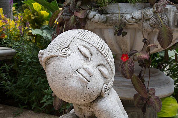 istock Girl sculpture in the garden. 519407351
