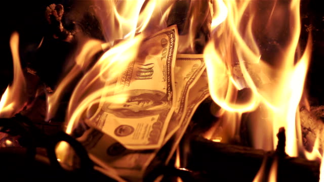 Two videos of burning money in real slow motion