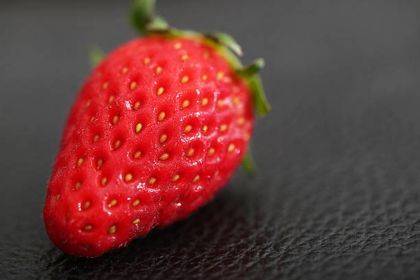 istock Strawberry on the black leather 519422236
