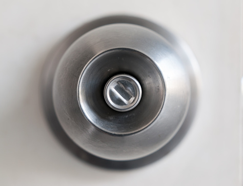 A door knob with a white door.