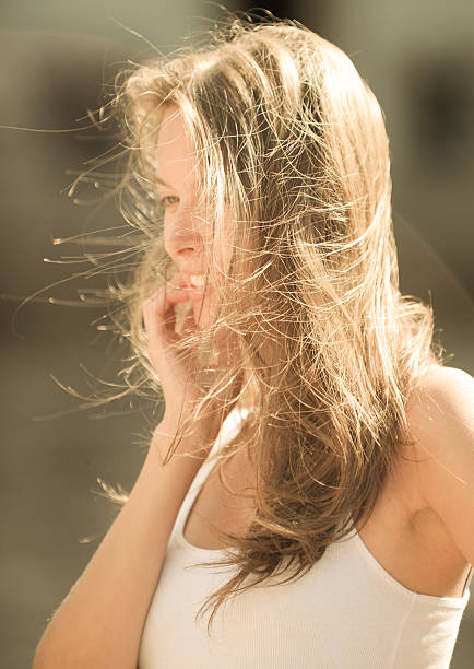 istock Beautiful Young Woman Touching her Hairs 519424360
