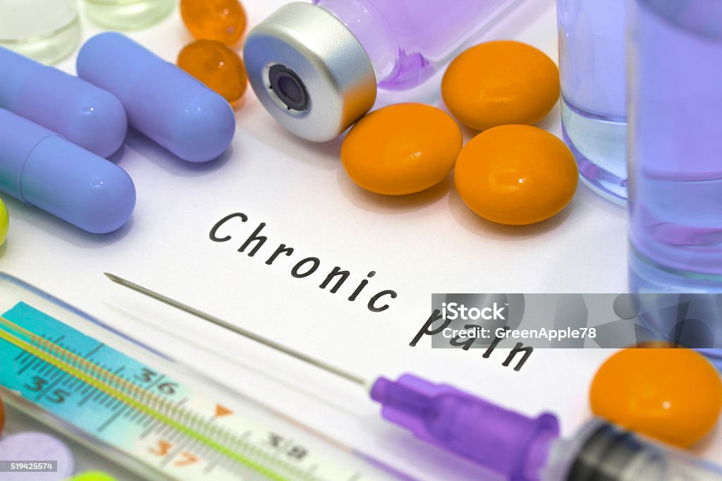 chronic pain Chronic pain - diagnosis written on a white piece of paper. Syringe and vaccine with drugs. Arthritis Stock Photo