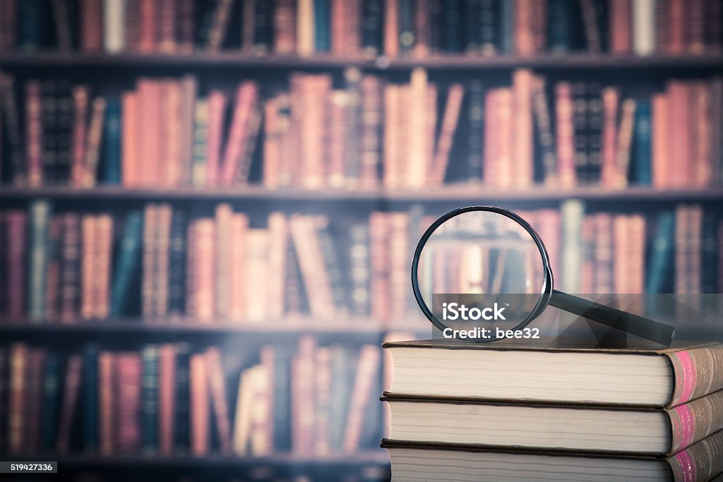 Books and magnifying glass Book Stock Photo