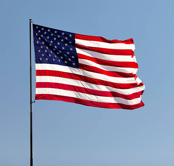 istock American Flag on pole in the wind USA 519428200