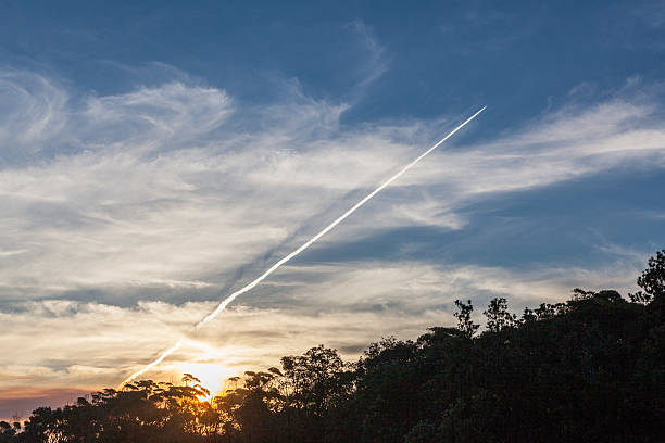 istock Jet plane trail, sunset landscape 519428374