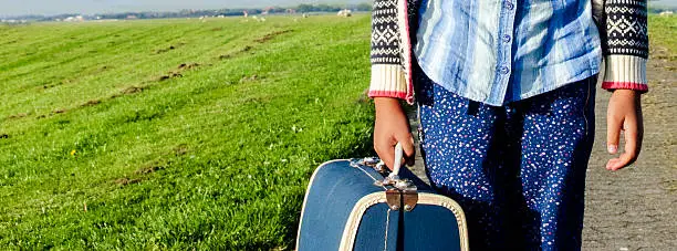 Ethnic Girl travelling alone with her suitcase