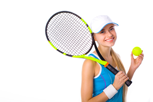 portrait of a beautiful smiling girl with a tennis racket and ball on a white background