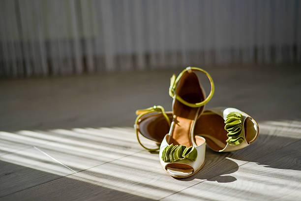 istock White sandals with green ribbon in with natural light 519431952