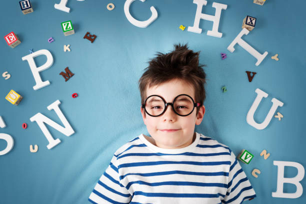 istock seven years old child lying with glasses and letters 519432232