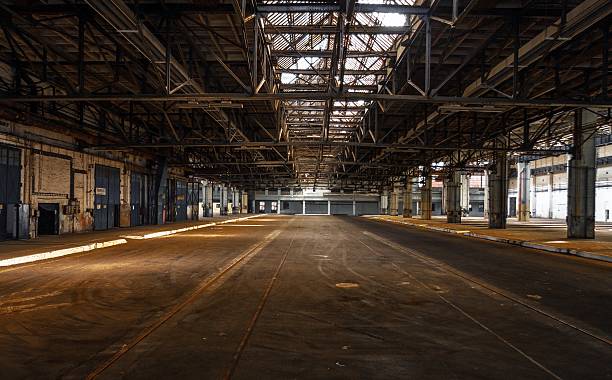Dark industrial interior Dark industrial interior of an old building airplane hangar photos stock pictures, royalty-free photos & images