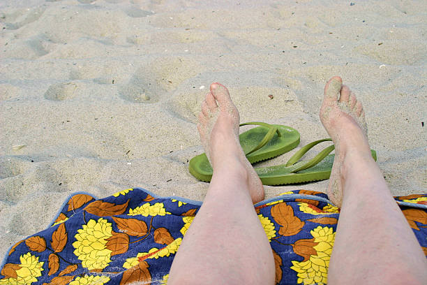 Woman legs Feet on the beach on a blanket beines stock pictures, royalty-free photos & images