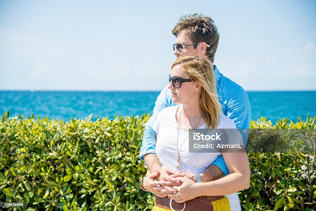 Enjoying outdoors Young couple embracing at the seaside. Adult Stock Photo