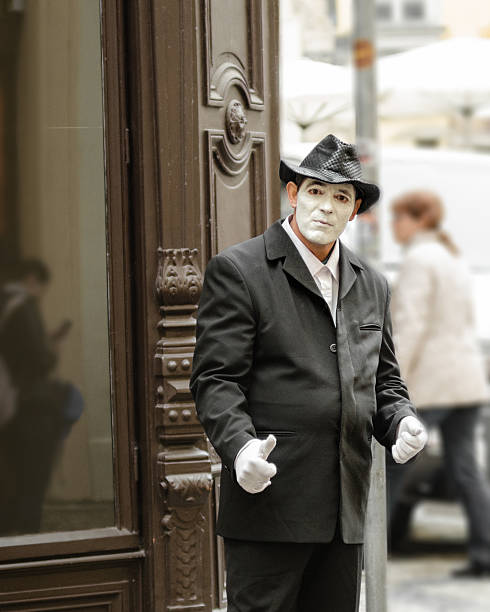 Portrait of the street mime with sad sight Prague, Czech Republic - September 26, 2014: Street mime with white face and gloves stands in Old Town Square the historic center of the Prague. pantomime dame stock pictures, royalty-free photos & images