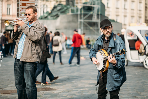 PRAGUE, CZECH REPUBLIC - October 8, 2014: Street Busker performing jazz songs at the Old Town Square in Prague. Busking is legal form of earning money on Prague Streets.