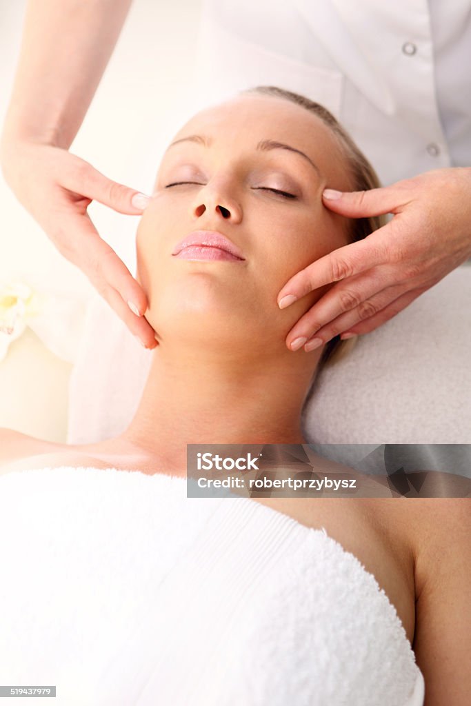 Beauty salon, the woman at face massage Portrait of a beautiful woman in a beauty salon, relaxation, luxury, peace  Adult Stock Photo