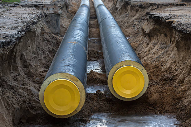 Unfinished pipeline Work in progress, burying pipeline in a urban area. piping hot stock pictures, royalty-free photos & images