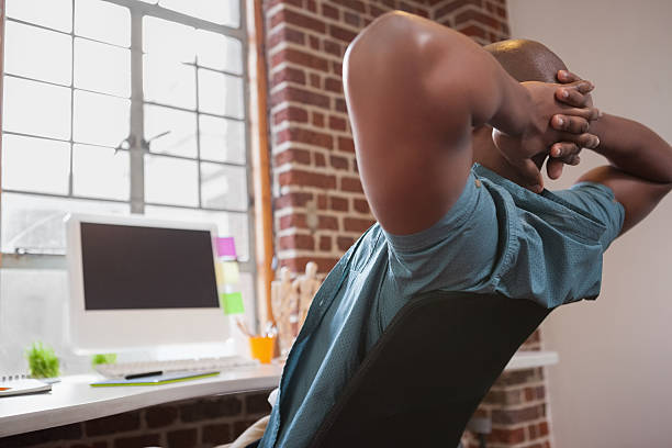 istock Casual businessman leaning back in chair 519439599