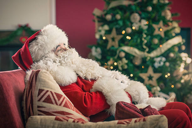 istock Santa Claus sitting on a red couch 519439757