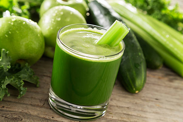 Kale Juice Juicing - A glass of juice with vegetables and fruit. Please see my portfolio for other food and drink images. celery juice stock pictures, royalty-free photos & images