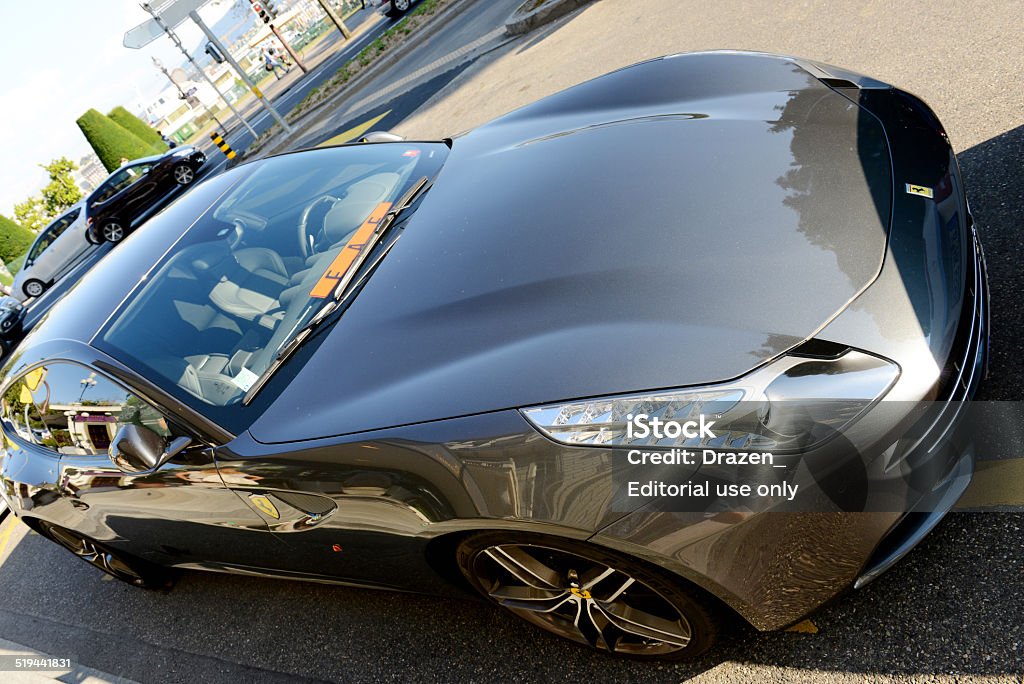 Ferrari FF parked on street of geneve, Switzerland Geneve, Switzerland - September 4, 2014: Four wheel drive Ferrari FF parked on the street in Geneva, near the lake. Fastest four-seat car in the world - maximum speed at 208 mph and 0-62 mph sprint in 3.7 seconds, will be produced in only 800 units this year.  Car Stock Photo