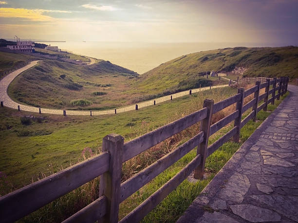 Winding stone road leading to the Cantabric sea in Gijon town, Asturias, Spain
