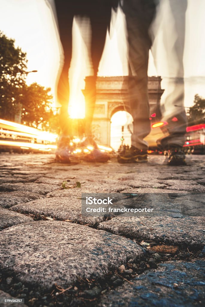 Leg tourist in front at the Arc de Triomphe Rush hour at the Arc de Triomphe in Paris Activity Stock Photo