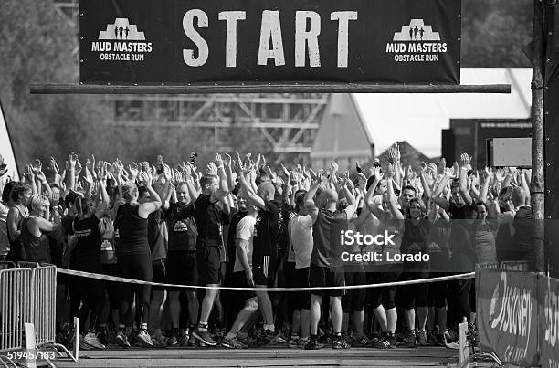 Participants With Hands In Air At Start Of Mud Run Stock Photo - Download Image Now - Adult, Adversity, Athlete