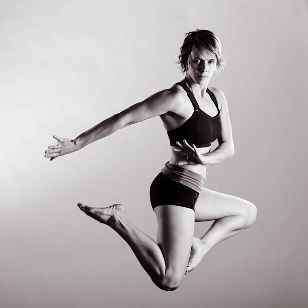 istock Fitness - Jumping Female in Dramatic Pose 519457197