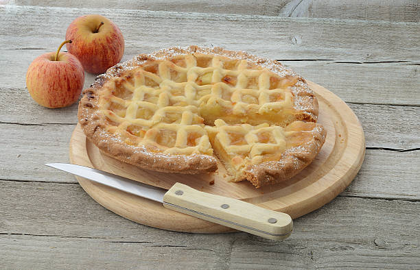 Apple pie with knife and apples stock photo