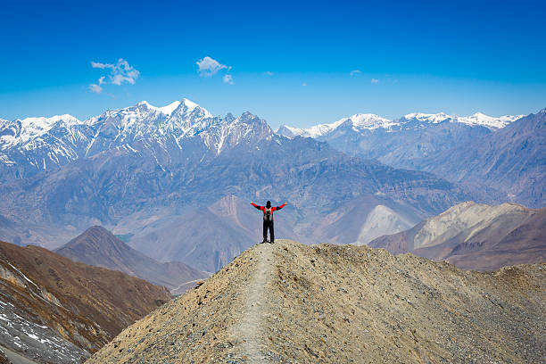 Man hiker with arms raised Annapurna trek, Nepal