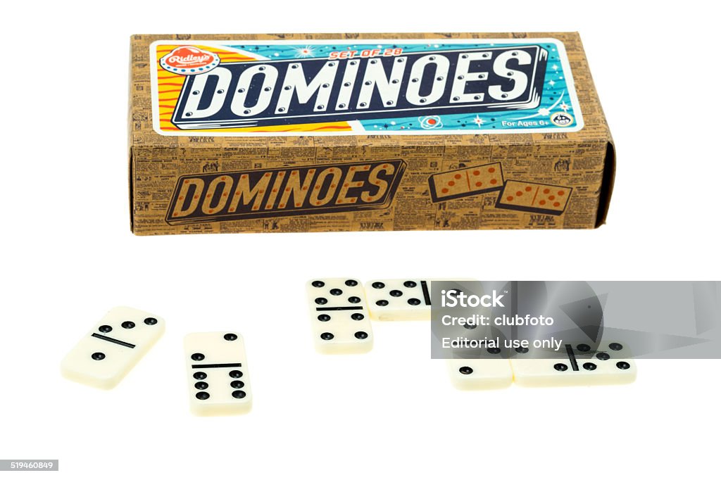 Dominoes and retail packaging London, United Kingdom - October 15, 2014: Classic dominoes tiles and game set manufactured by Ridleys and with cardboard packaging. Many of the old fashioned and traditional games are being reintroduced to the marketplace with a retro look to the packaging - this is a studio shot with a white background Domino Stock Photo