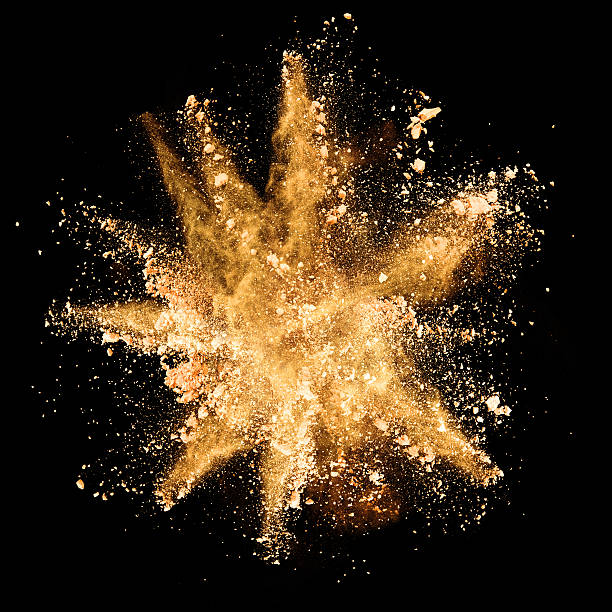 istock Explosion of brown powder on black background 519466138