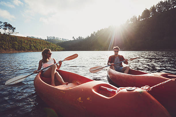 istock Young couple kayaking on a lake together 519468078