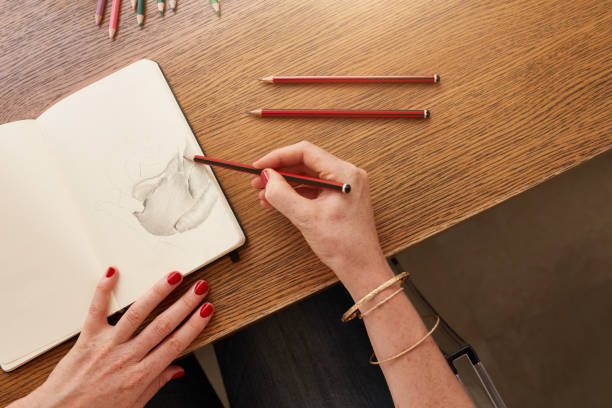 istock Female artist working with pencil sketch 519468632