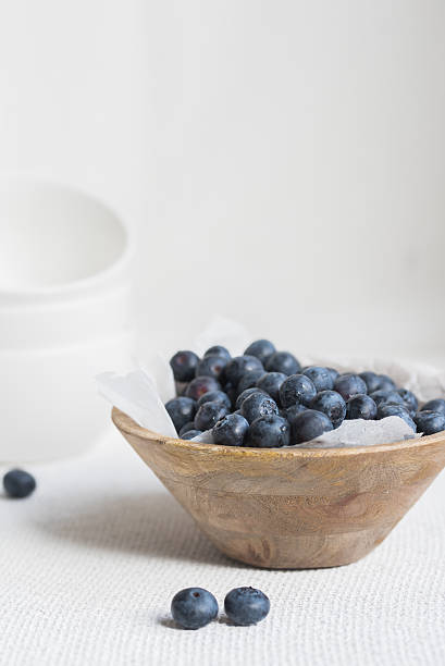 istock blueberries in wooden bowl 519469528