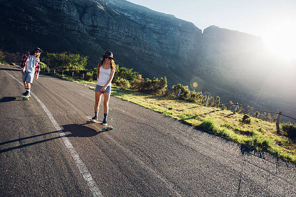 istock Two young people skating outdoors on rural road 519469738