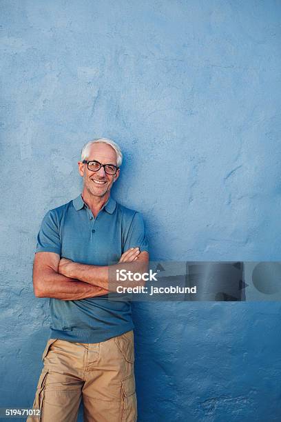 Smiling Mature Man Standing With His Arms Crossed Stock Photo - Download Image Now - Mature Men, Men, Senior Adult