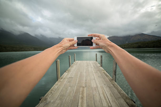 istock Personal perspective of person taking picture using mobile phone-Pier 519471554