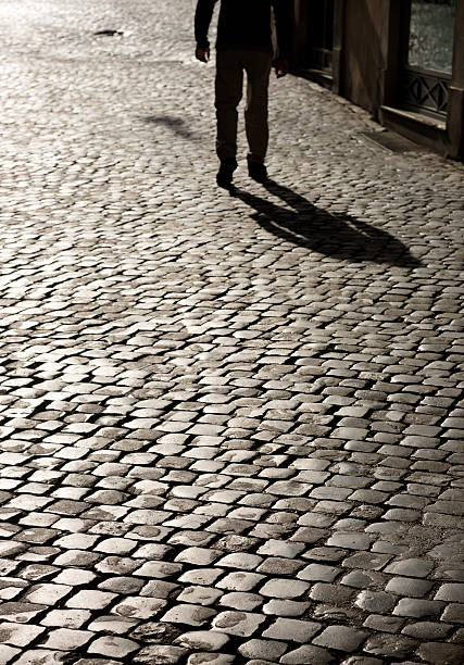 istock Roman cobblestone leg silhouette, Rome Italy 519471690