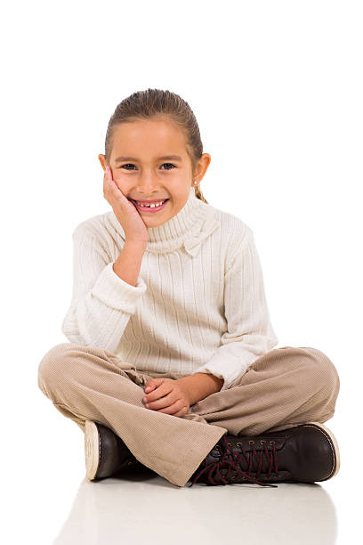 istock little girl sitting on white 519471783