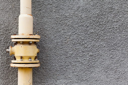 gray wall gas pipe rust points